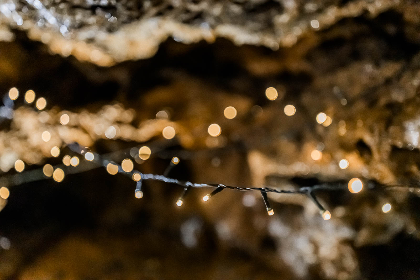 Photographie de Mathieu Dété, photographe de mariage sur l'île de la Réunion à Saint-Pierre, présentant le détail des guirlandes de décoration du mariage dans un tunnel de lave